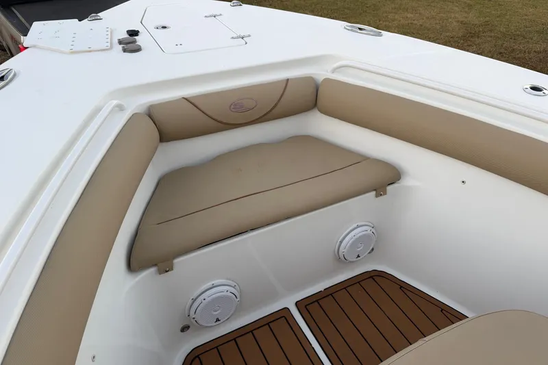 Slide: The Image of 2018 Sea Hunt Gamefish 30 Coffin Box boat interior with cushioned seating and speakers. - 11