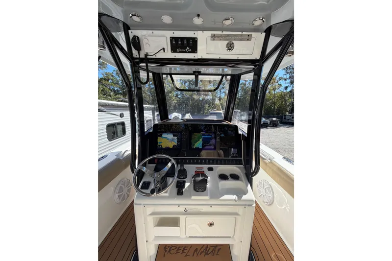 Slide: The Image of 2018 Sea Hunt Gamefish 30 Coffin Box boat dashboard with navigation screens and controls. - 14