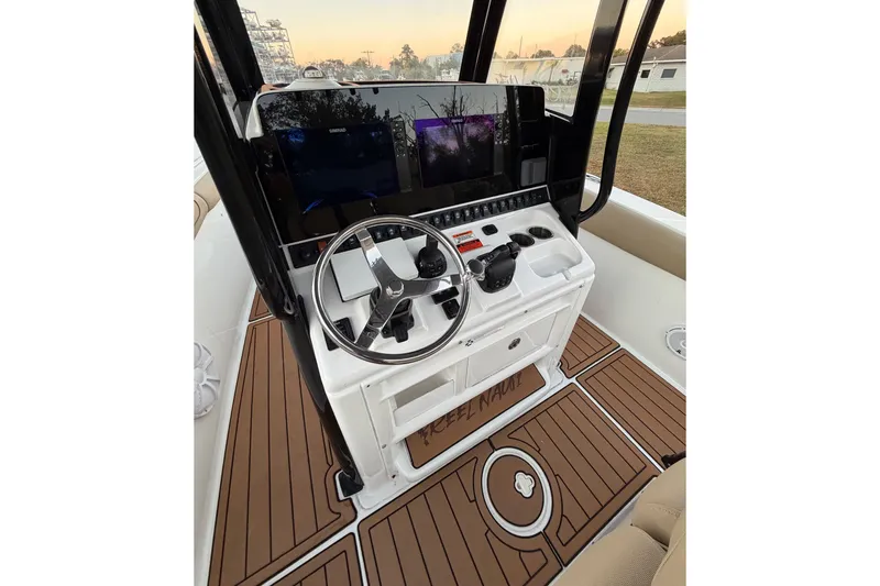 Slide: The Image of 2018 Sea Hunt Gamefish 30 Coffin Box helm with modern controls and wood-style flooring. - 15