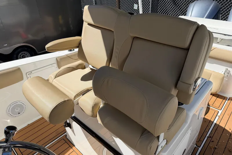 Slide: The Image of 2018 Sea Hunt Gamefish 30 boat seating with tan upholstery and armrests. - 18