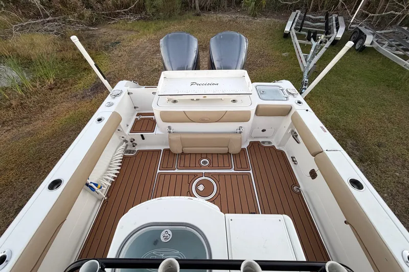 Slide: The Image of 2018 Sea Hunt Gamefish 30 Coffin Box boat interior with dual engines and wooden deck. - 21