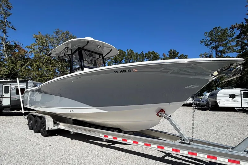 Slide: The Image of 2018 Sea Hunt Gamefish 30 Coffin Box boat on trailer, parked outdoors. - 3