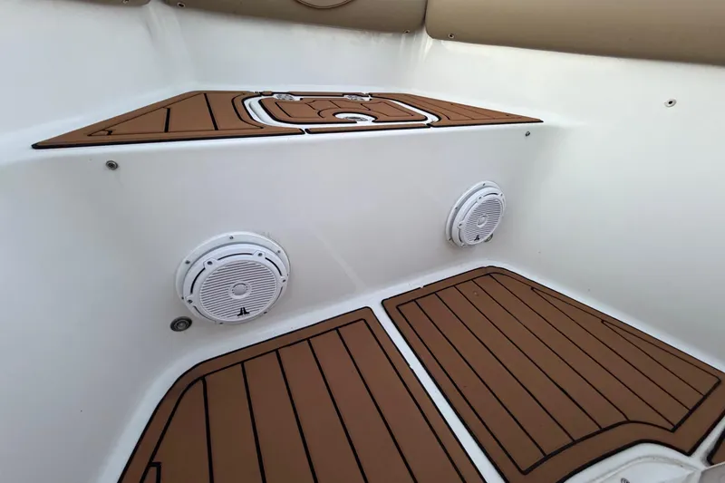 Slide: The Image of 2018 Sea Hunt Gamefish 30 Coffin Box interior with speakers and teak-style flooring. - 50