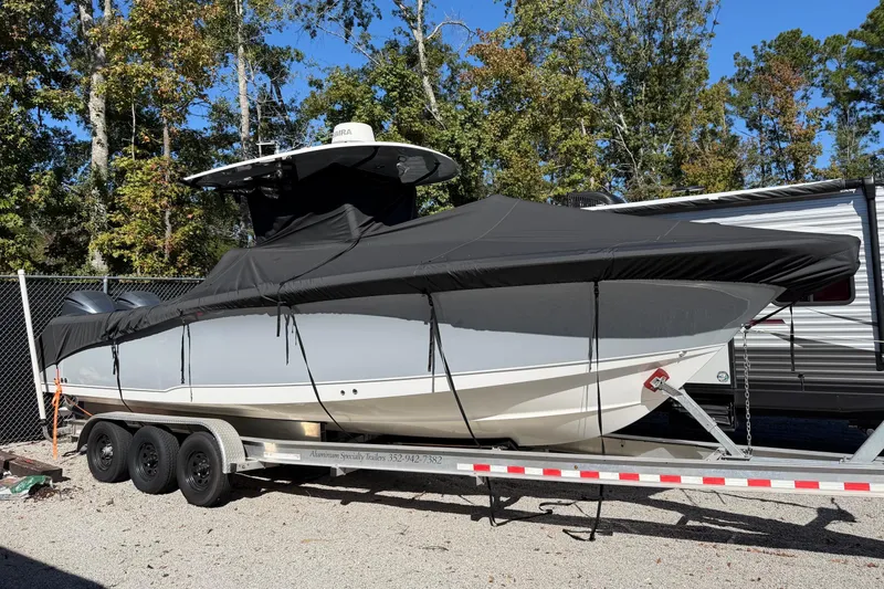 Slide: The Image of 2018 Sea Hunt Gamefish 30 Coffin Box boat on trailer, covered, outdoors. - 54
