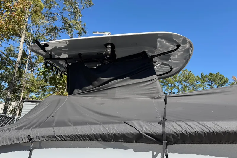 Slide: The Image of 2018 Sea Hunt Gamefish 30 Coffin Box boat with cover, under clear blue sky. - 55