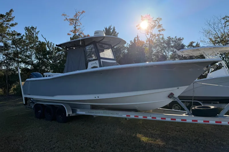 Slide: The Image of 2018 Sea Hunt Gamefish 30 Coffin Box boat on trailer, parked outdoors. - 56