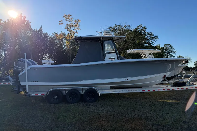 Slide: The Image of 2018 Sea Hunt Gamefish 30 Coffin Box boat on trailer, parked outdoors. - 57