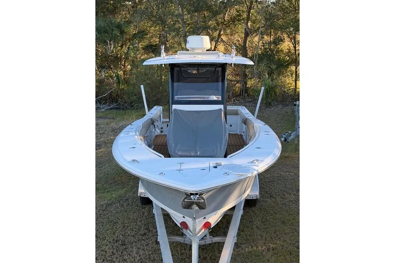 Slide: The Image of 2018 Sea Hunt Gamefish 30 Coffin Box boat on trailer, surrounded by trees. - 58