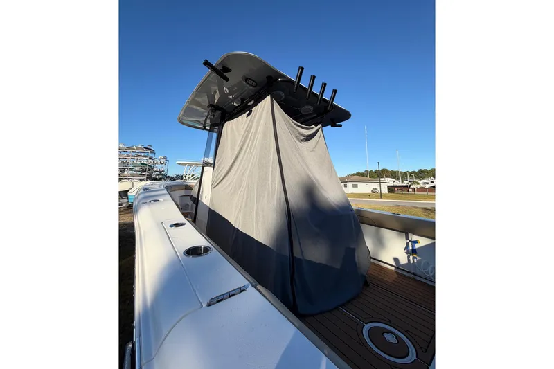 Slide: The Image of 2018 Sea Hunt Gamefish 30 Coffin Box boat with covered console, docked outdoors. - 60