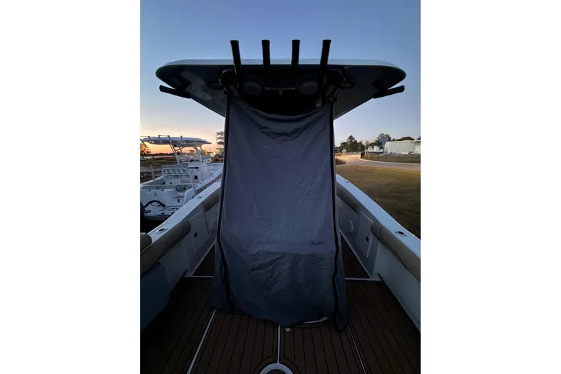 Slide: The Image of 2018 Sea Hunt Gamefish 30 Coffin Box boat at sunset, covered deck view. - 61
