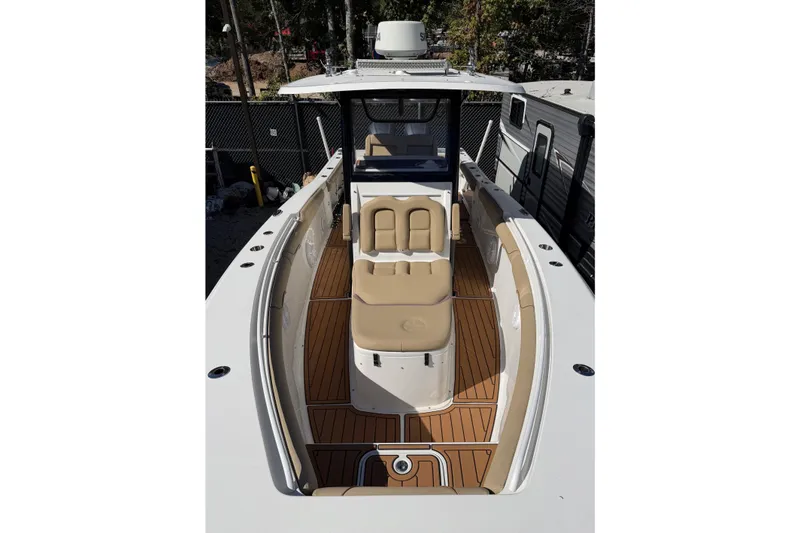 Slide: The Image of 2018 Sea Hunt Gamefish 30 Coffin Box boat with tan seating and wood-style deck. - 7