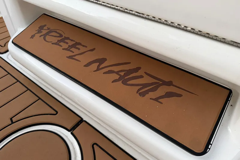 Slide: The Image of "Reel Nauti" logo on 2018 Sea Hunt Gamefish 30 Coffin Box boat deck. - 76