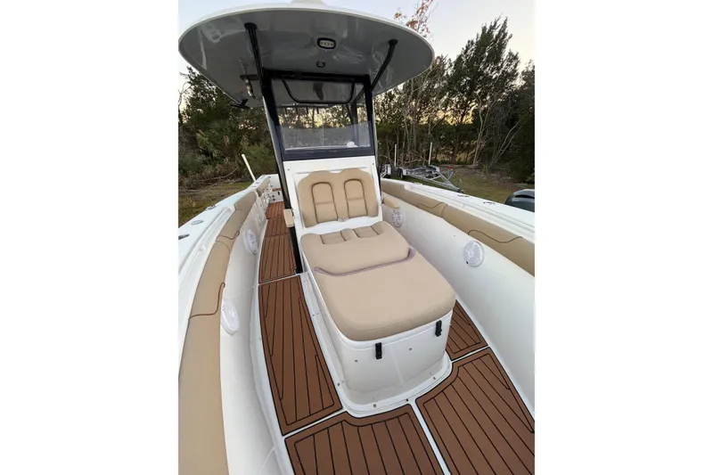 Slide: The Image of 2018 Sea Hunt Gamefish 30 Coffin Box boat interior with cushioned seating and wood-style flooring. - 8