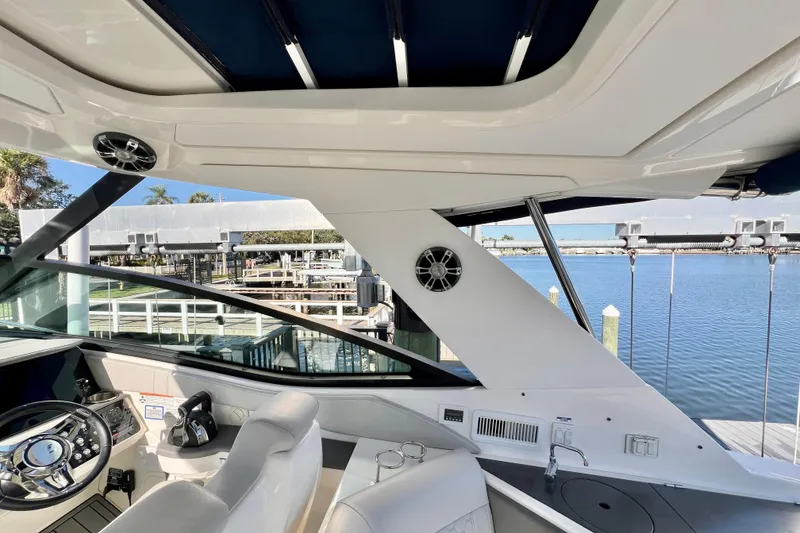 Slide: The Image of Interior view of 2020 Sea Ray Sundancer 320 yacht with helm and seating area. - 25