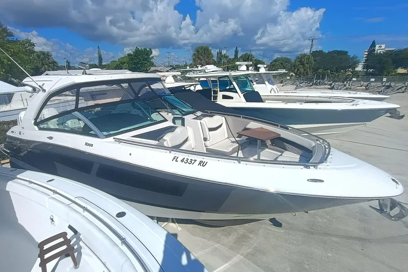 The Image of 2019 Four Winns H350 OB boat docked under a clear blue sky. - 1