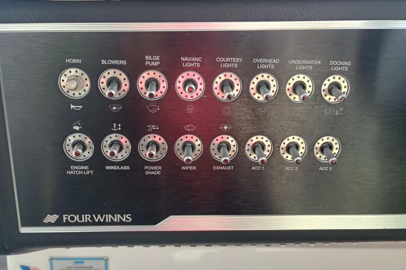 Slide: The Image of Control panel of a 2019 Four Winns H350 OB boat with labeled switches. - 10