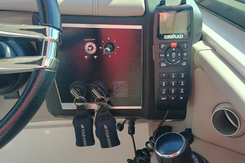 Slide: The Image of Control panel of a 2019 Four Winns H350 OB boat with Simrad radio. - 11
