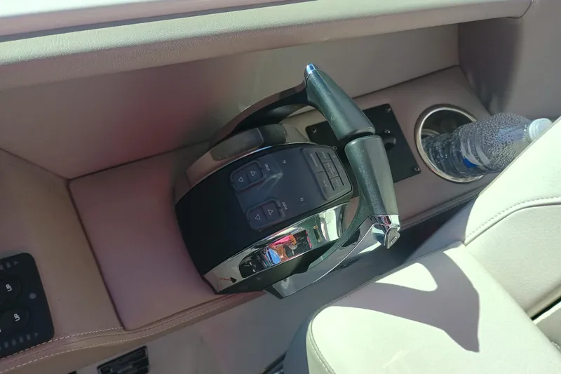 Slide: The Image of 2019 Four Winns H350 OB throttle control and cup holder with water bottle. - 13