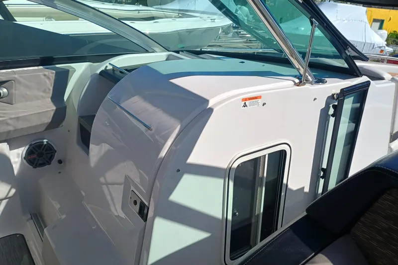 Slide: The Image of 2019 Four Winns H350 OB boat interior with sleek dashboard and modern design. - 5