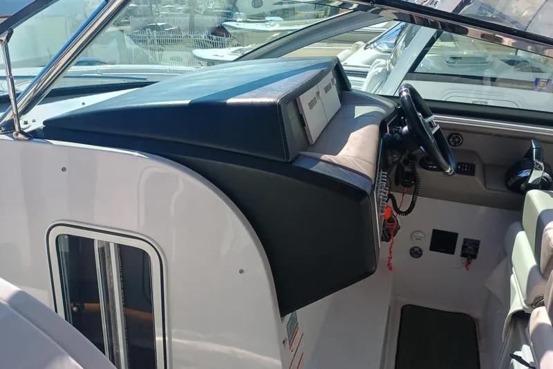 Slide: The Image of 2019 Four Winns H350 OB boat cockpit with steering wheel and control panel. - 8