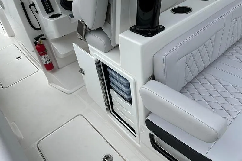 Slide: The Image of 2025 Fountain 38 Center Console interior with white seating and storage compartments. - 10