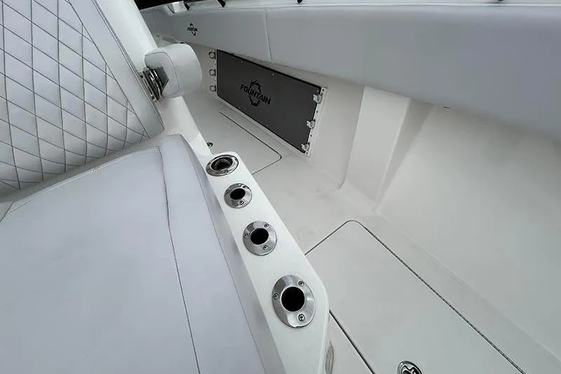 Slide: The Image of 2025 Fountain 38 Center Console interior with white seating and rod holders. - 15