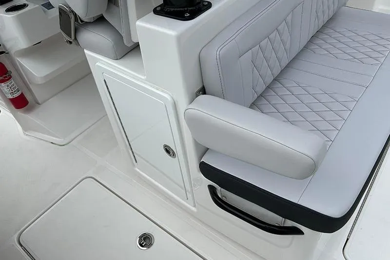 Slide: The Image of 2025 Fountain 38 Center Console interior with quilted seating and storage compartment. - 9