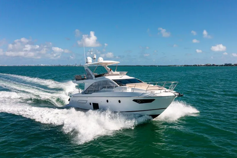 The Image of 2020 Azimut AZ 50-Fly yacht cruising on open water under clear blue skies. - 0