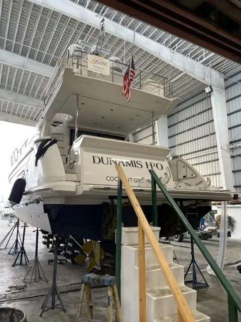 Slide: The Image of 2020 Azimut AZ 50-Fly yacht in a boatyard, rear view with American flag. - 46