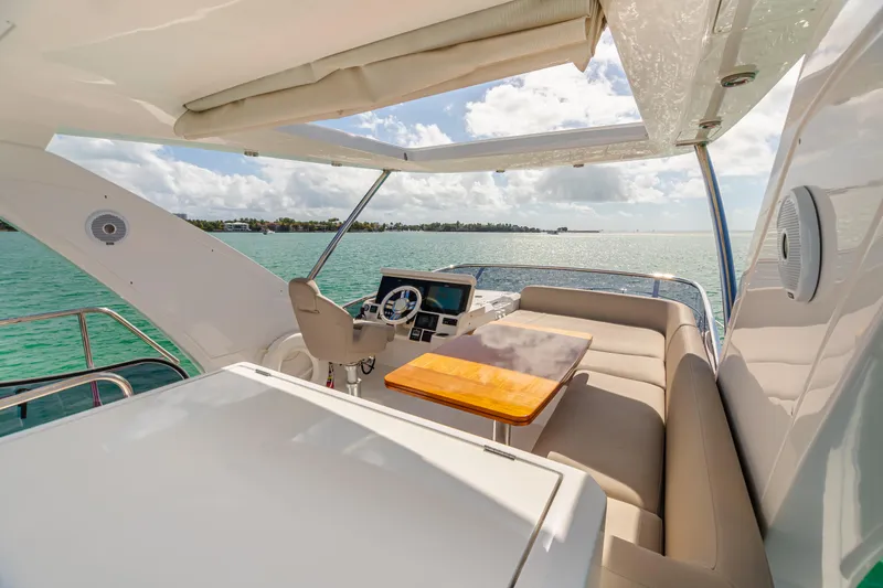 Slide: The Image of 2020 Azimut AZ 50-Fly yacht flybridge with seating, table, and ocean view. - 8
