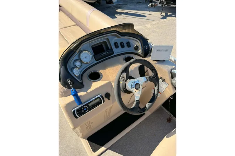 Slide: The Image of 2017 Sun Tracker Party Barge 22 DLX dashboard with steering wheel and controls. - 3