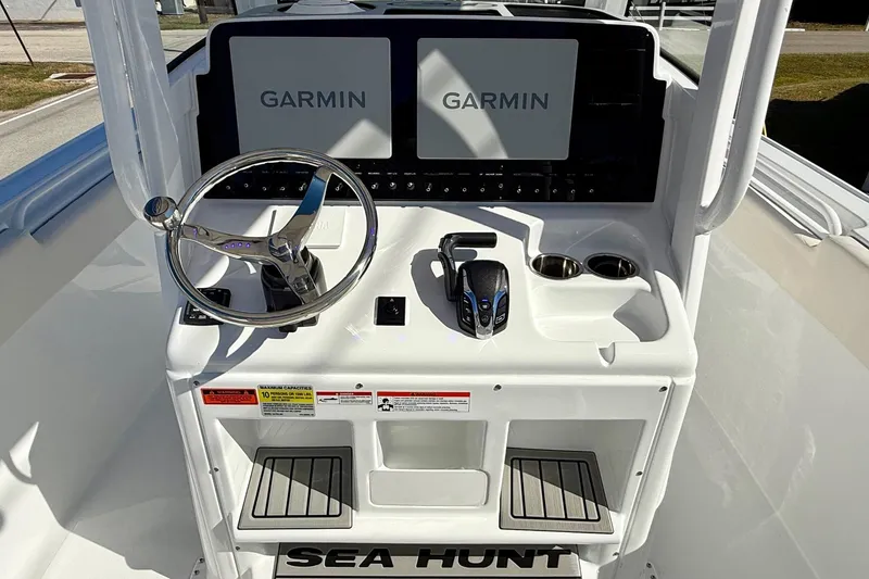 Slide: The Image of 2026 Sea Hunt Ultra 255 SE boat console with Garmin displays and steering wheel. - 10