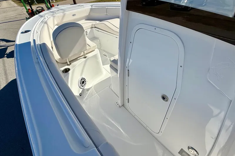 Slide: The Image of 2026 Sea Hunt Ultra 255 SE boat interior with seating and storage compartment. - 12