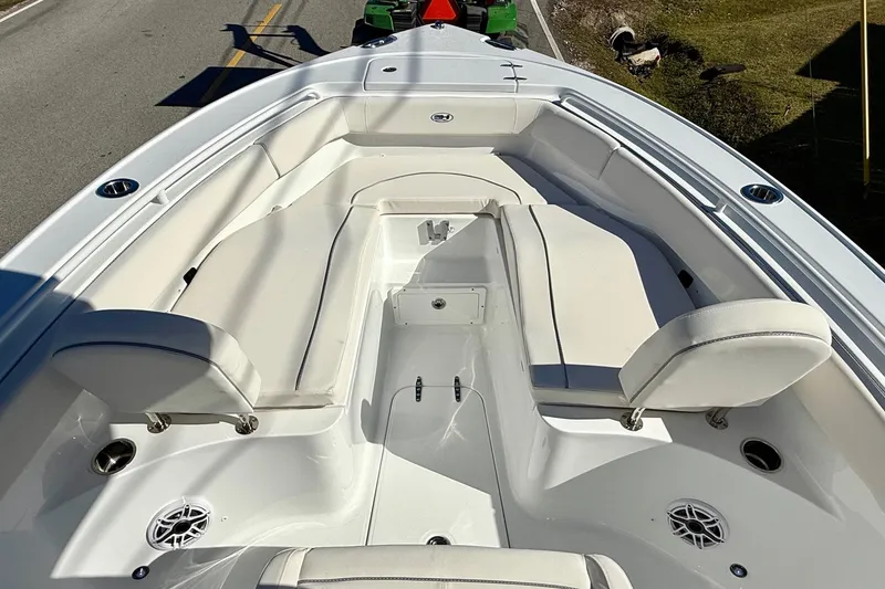 Slide: The Image of 2026 Sea Hunt Ultra 255 SE boat interior with white seating and cup holders. - 14