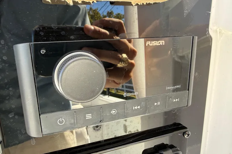 Slide: The Image of Fusion marine stereo system on a 2026 Sea Hunt Ultra 255 SE boat dashboard. - 18