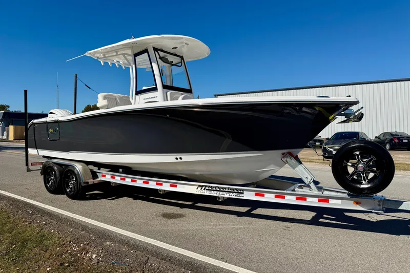 Slide: The Image of 2026 Sea Hunt Ultra 255 SE boat on trailer, parked on a sunny day. - 5