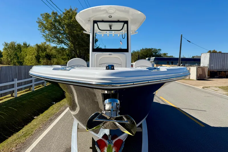 Slide: The Image of 2026 Sea Hunt Ultra 255 SE boat on trailer, parked on a sunny street. - 6