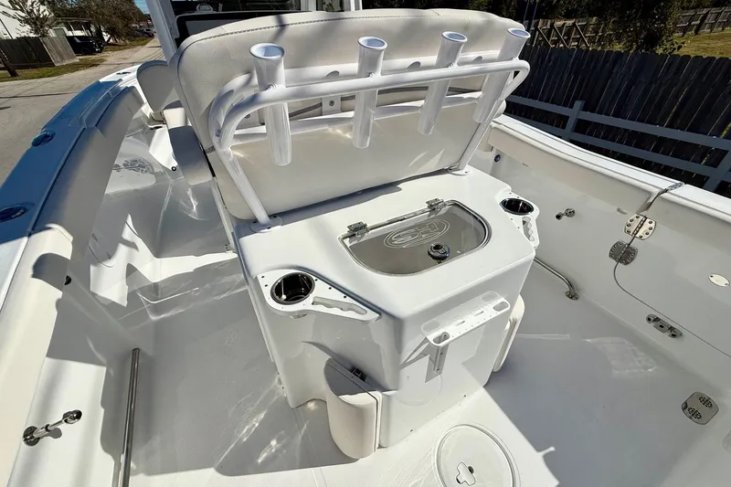 Slide: The Image of 2026 Sea Hunt Ultra 255 SE boat interior with rod holders and storage compartments. - 8