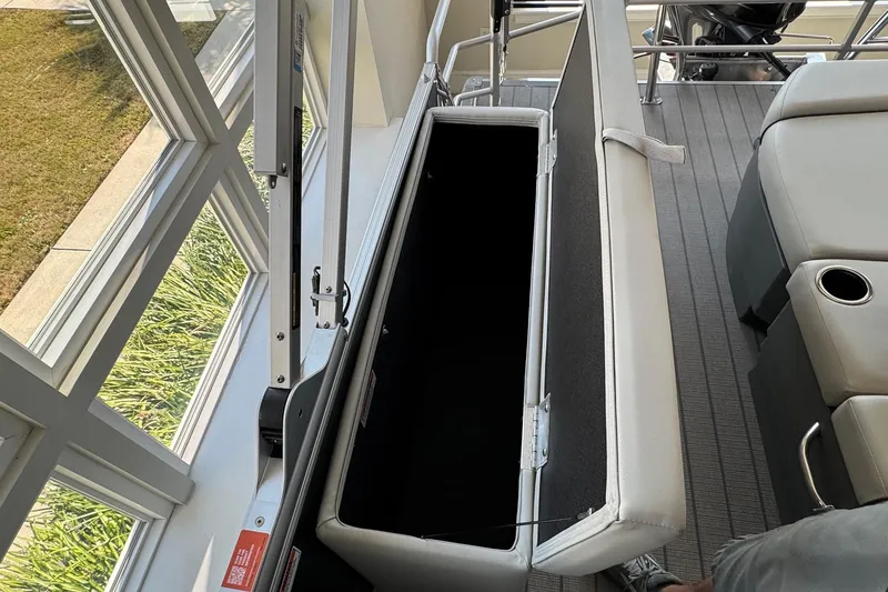 Slide: The Image of Open storage compartment on 2026 Starcraft EX 20 Q DH boat with seating and cup holder. - 17