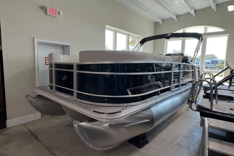 Slide: The Image of 2026 Starcraft EX 20 Q DH pontoon boat displayed indoors. - 3