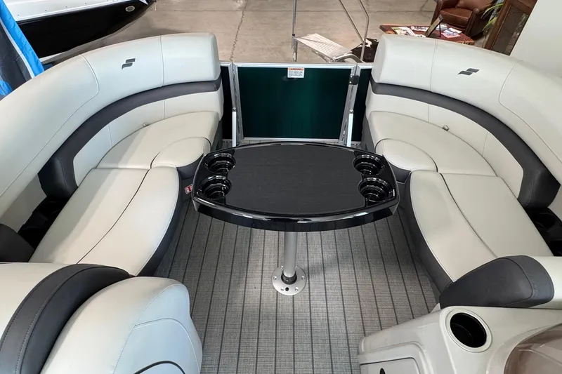 Slide: The Image of 2026 Starcraft EX 20 Q DH boat interior with plush seating and central table. - 7