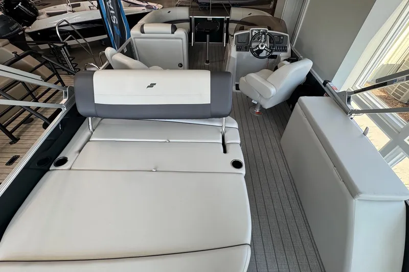 Slide: The Image of 2026 Starcraft EX 20 Q DH boat interior with plush seating and modern helm. - 12