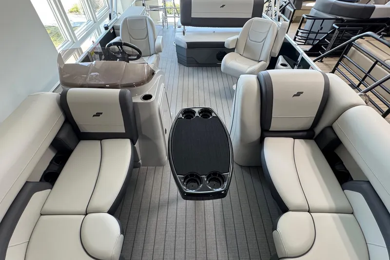 Slide: The Image of Luxurious interior of 2026 Starcraft EX 20 Q DH pontoon boat with plush seating and table. - 6