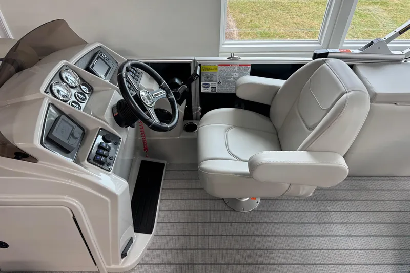 Slide: The Image of Captain's seat and helm of 2026 Starcraft EX 20 Q DH boat, featuring modern controls. - 8