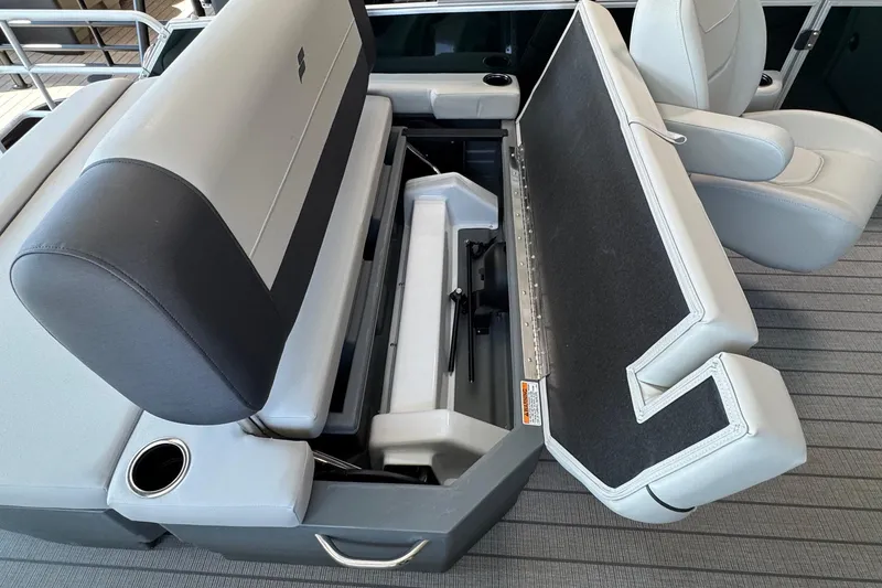 Slide: The Image of 2026 Starcraft EX 20 Q DH boat seat with storage compartment open. - 9