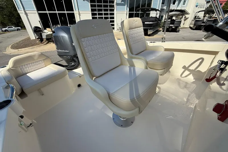 Slide: The Image of 2026 Scout 188 Sportfish boat interior with cushioned seating and modern design. - 10