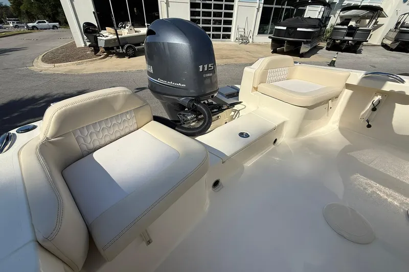 Slide: The Image of 2026 Scout 188 Sportfish boat interior with Yamaha 115 engine, featuring cushioned seating. - 11