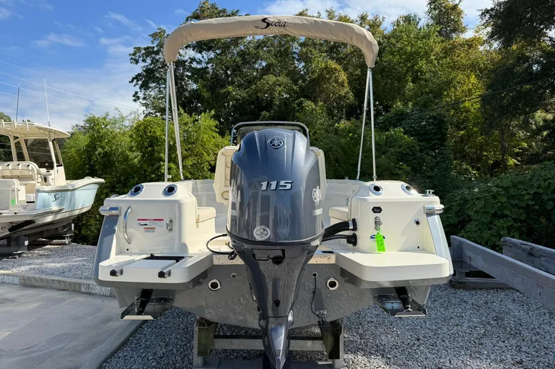 Slide: The Image of 2026 Scout 188 Sportfish boat with Yamaha 115 engine, parked outdoors. - 2