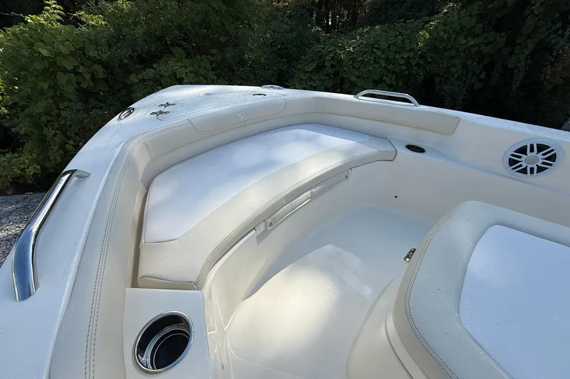 Slide: The Image of 2026 Scout 188 Sportfish boat interior with white seating and cup holders. - 5
