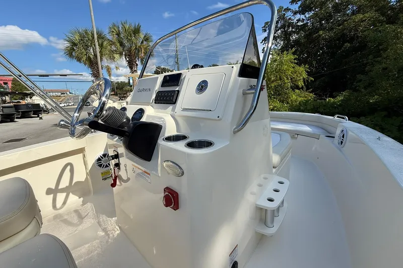 Slide: The Image of 2026 Scout 188 Sportfish boat interior with steering console and Garmin navigation system. - 8